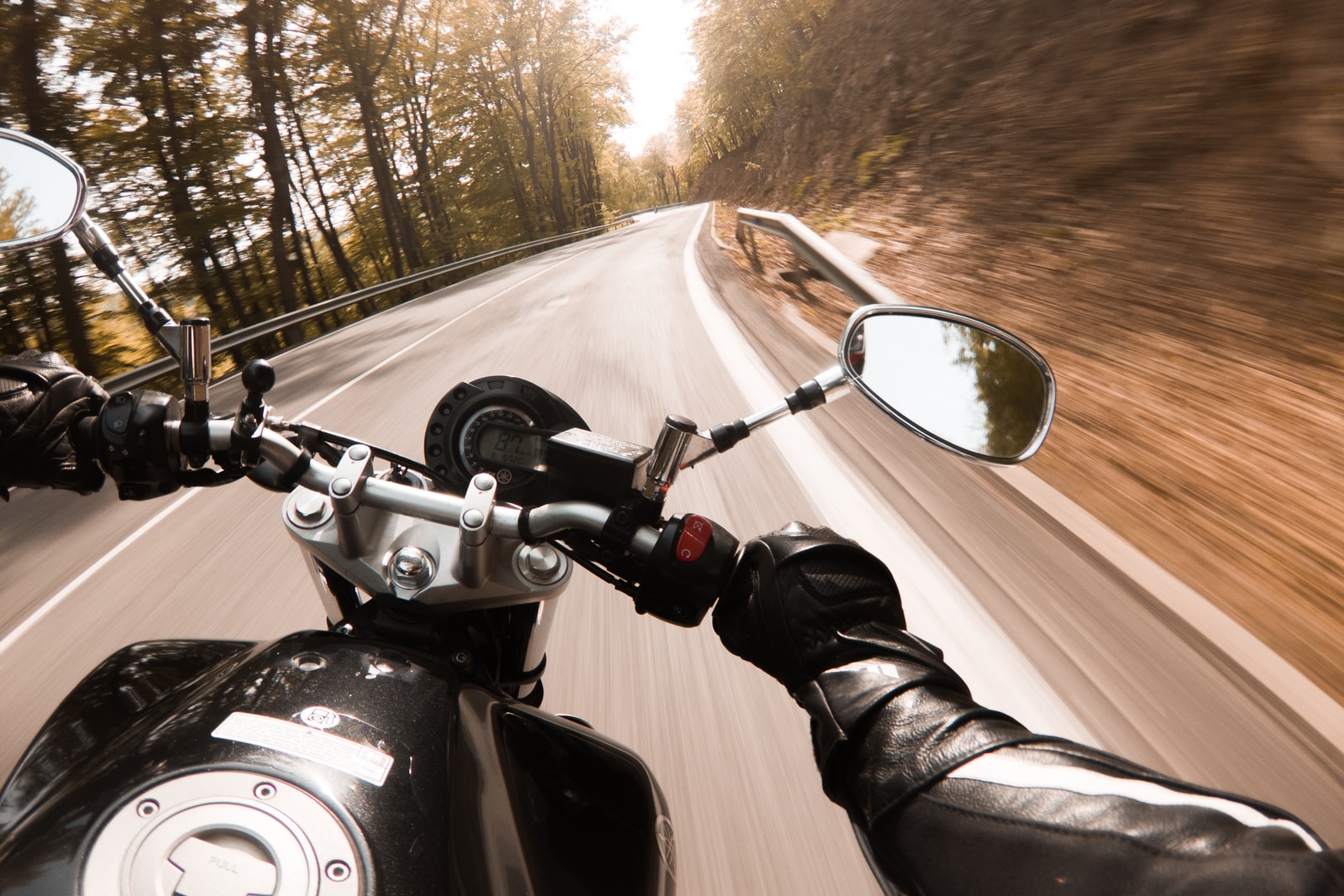 person riding motorcycle on road during daytime