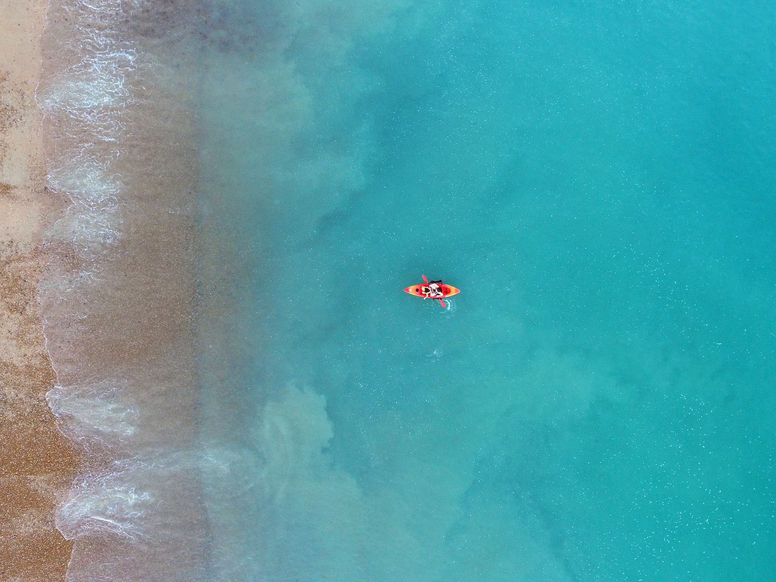 person kayaking on body of water