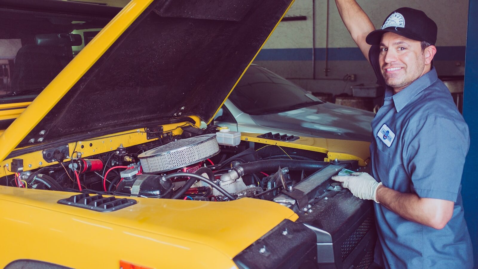 man holding open-wide car trunk