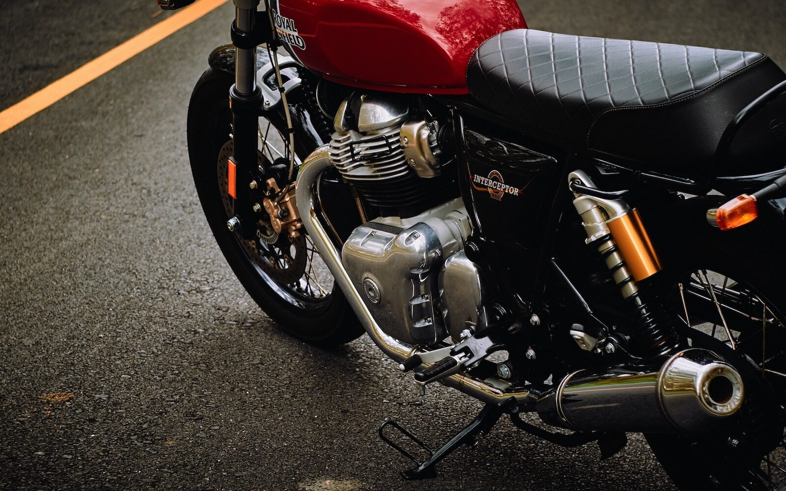 red and black motorcycle on gray asphalt road