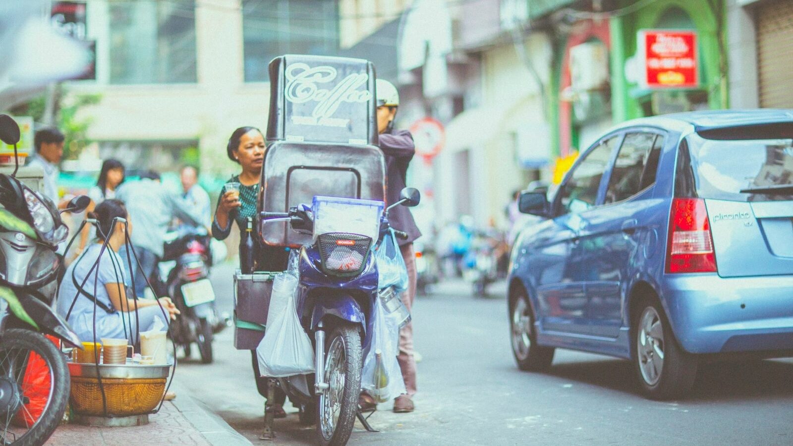 parked blue underbone motorcycle near road gutter