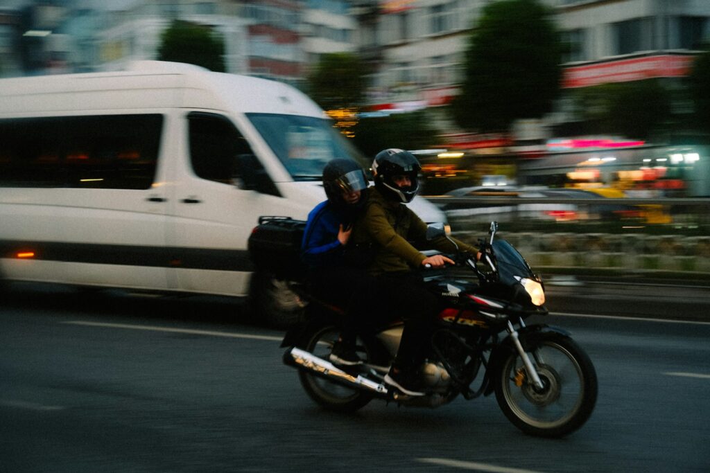 a couple of people ride a motorcycle