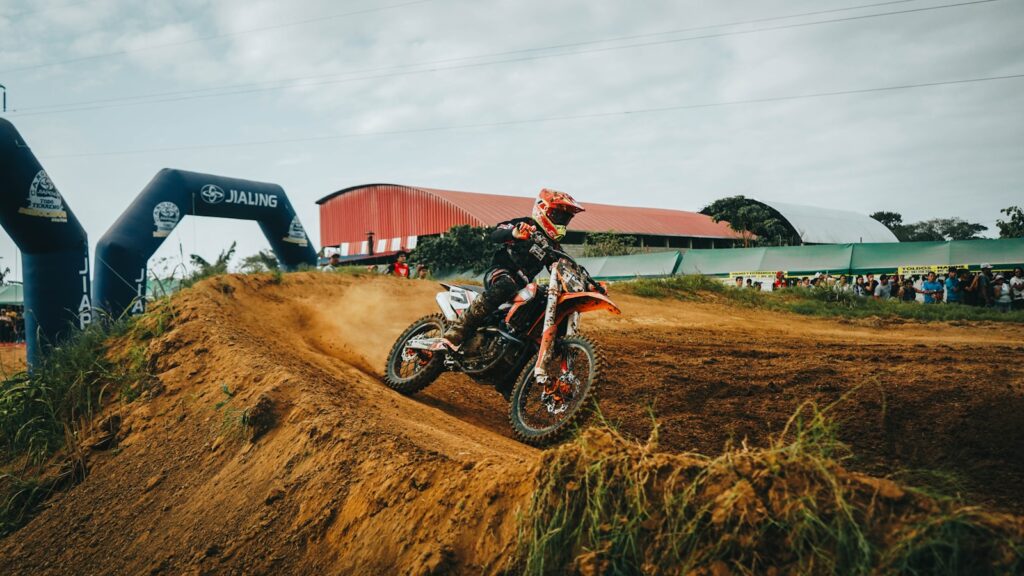 A person riding a dirt bike on a dirt track