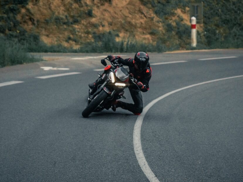 man in black jacket riding motorcycle on road during daytime