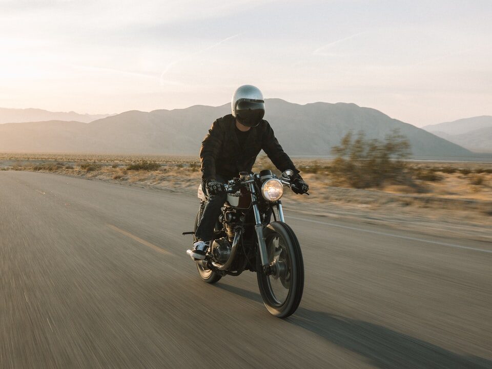 man riding motorcycle on road during daytime