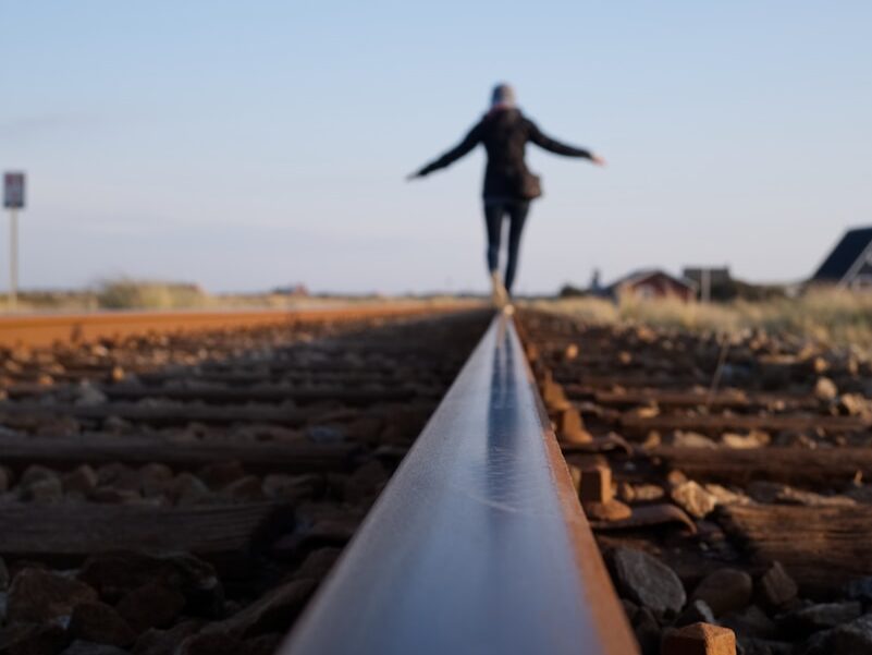 woman walking on train railway