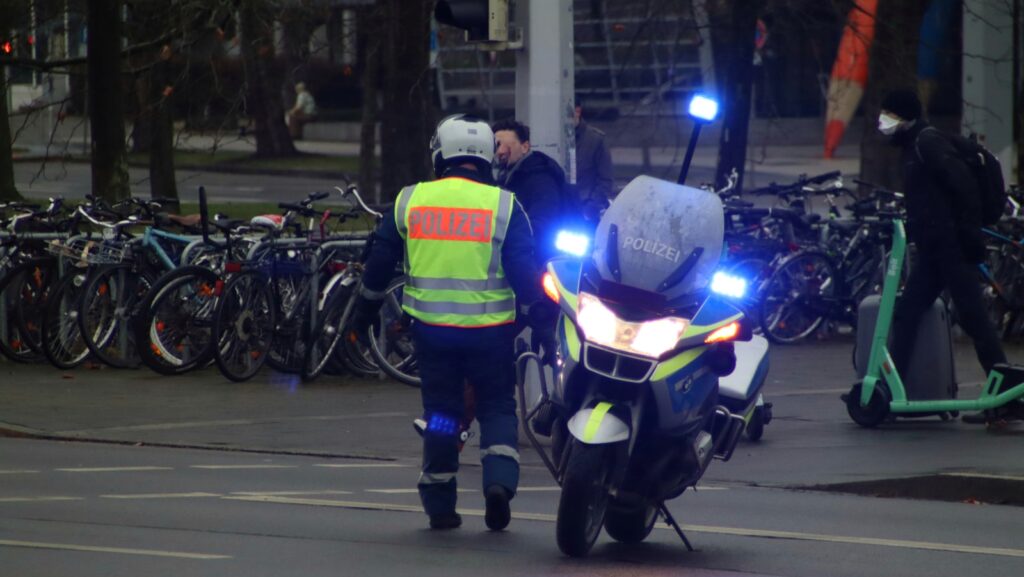 a police officer is standing next to a motorcycle