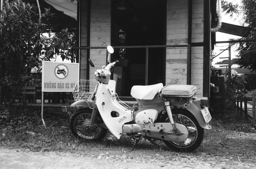 A motor scooter parked in front of a house