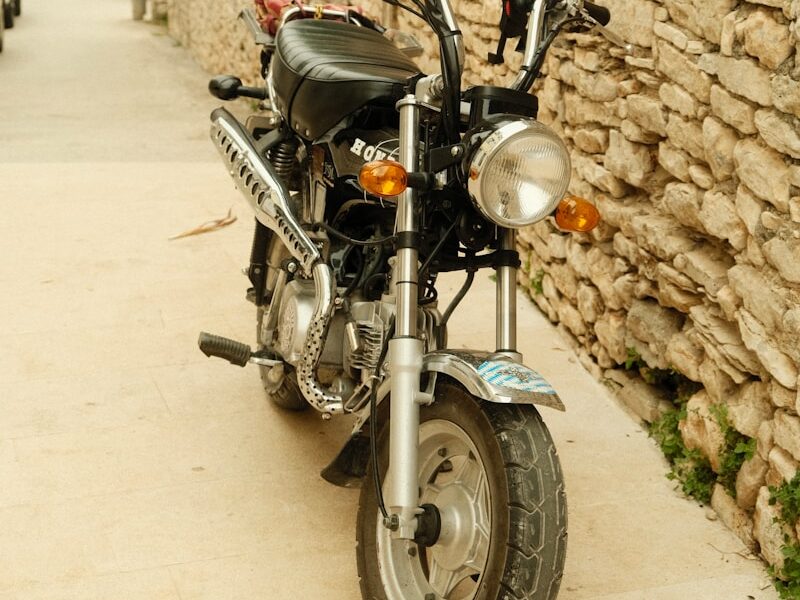A motorcycle parked next to a stone wall