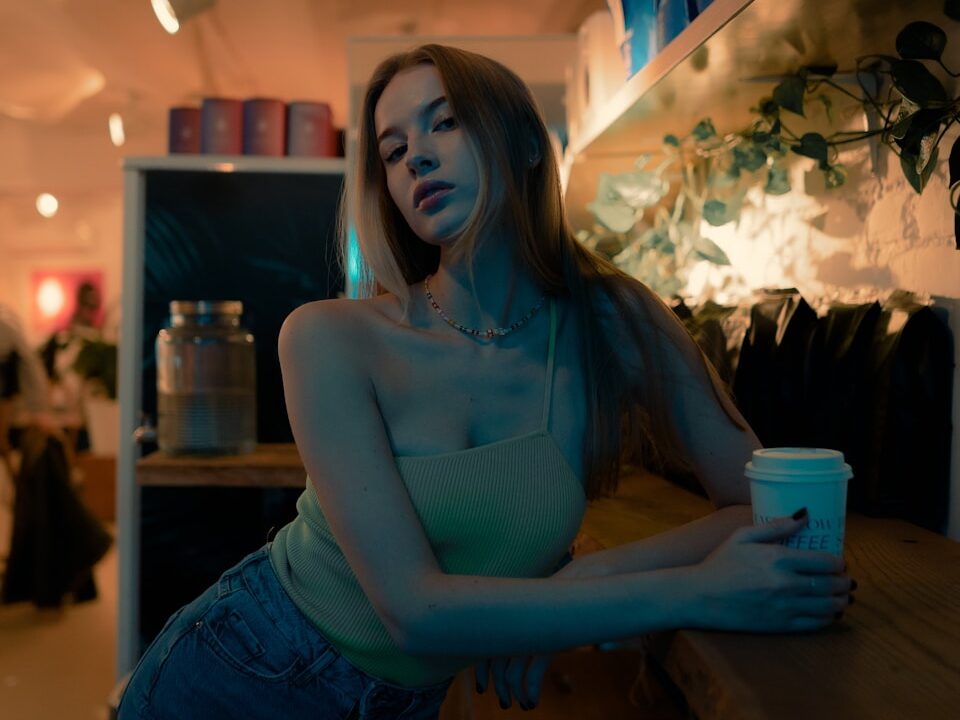 a woman sitting at a counter with a cup of coffee