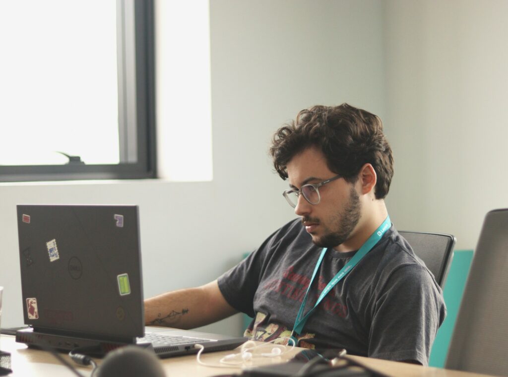 A man sitting in front of a laptop computer