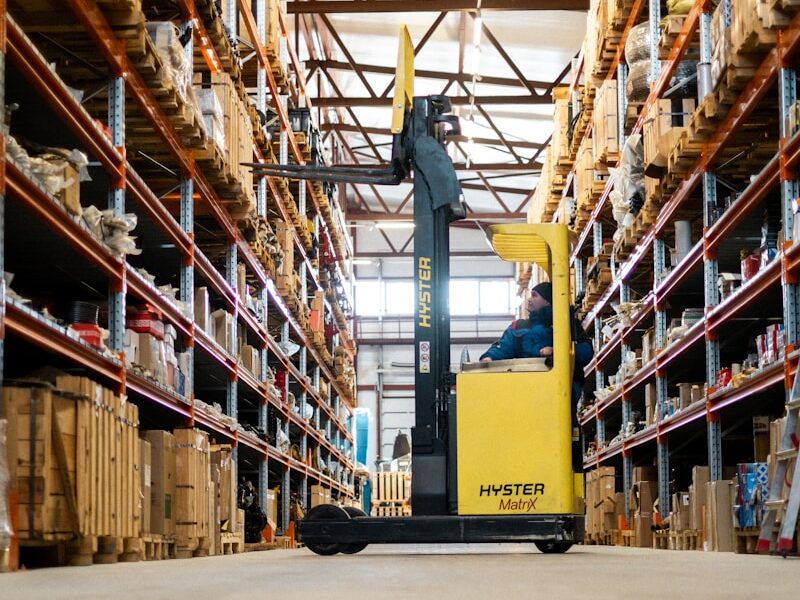 A yellow forklift in a large warehouse