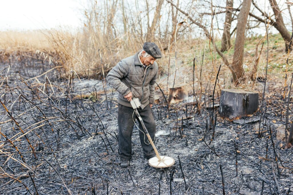 a man shoveling dirt in a field
