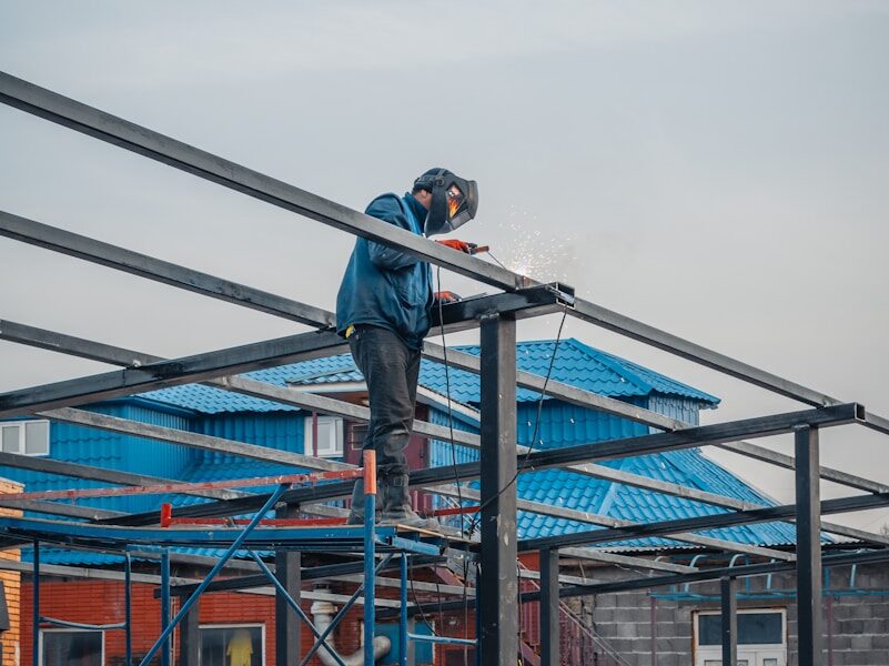 a man on a scaffold working on a building