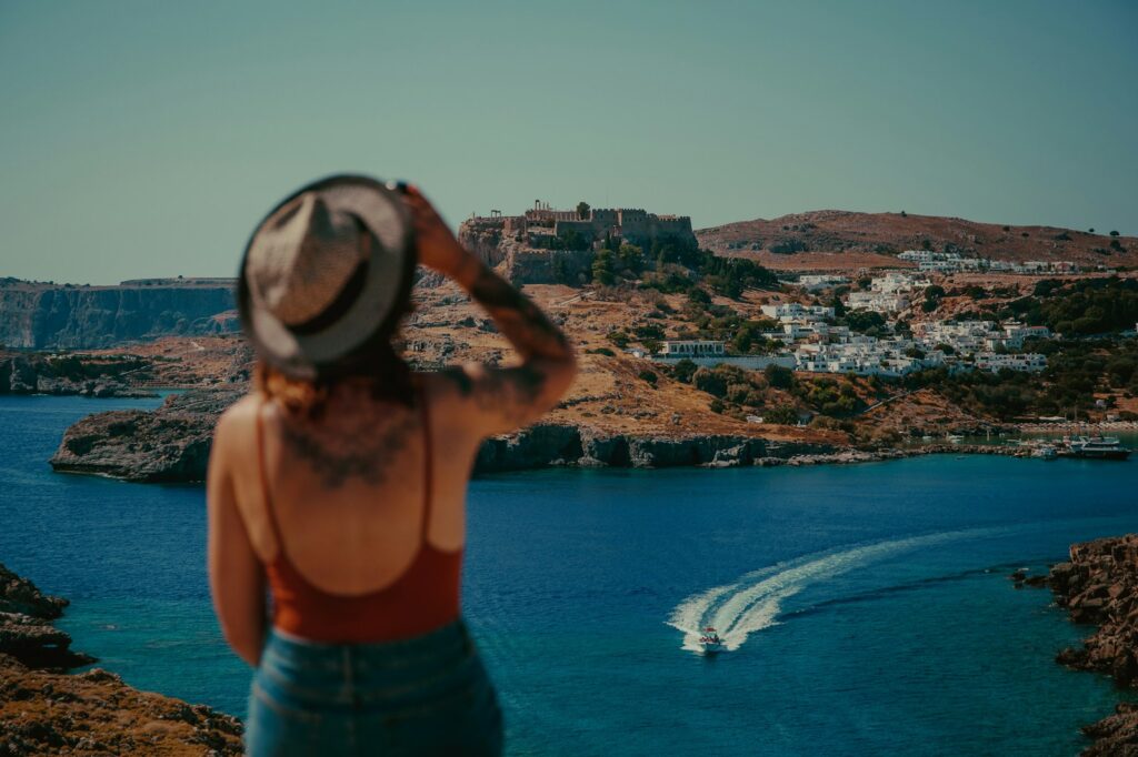 woman in blue denim shorts standing on top of building during daytime