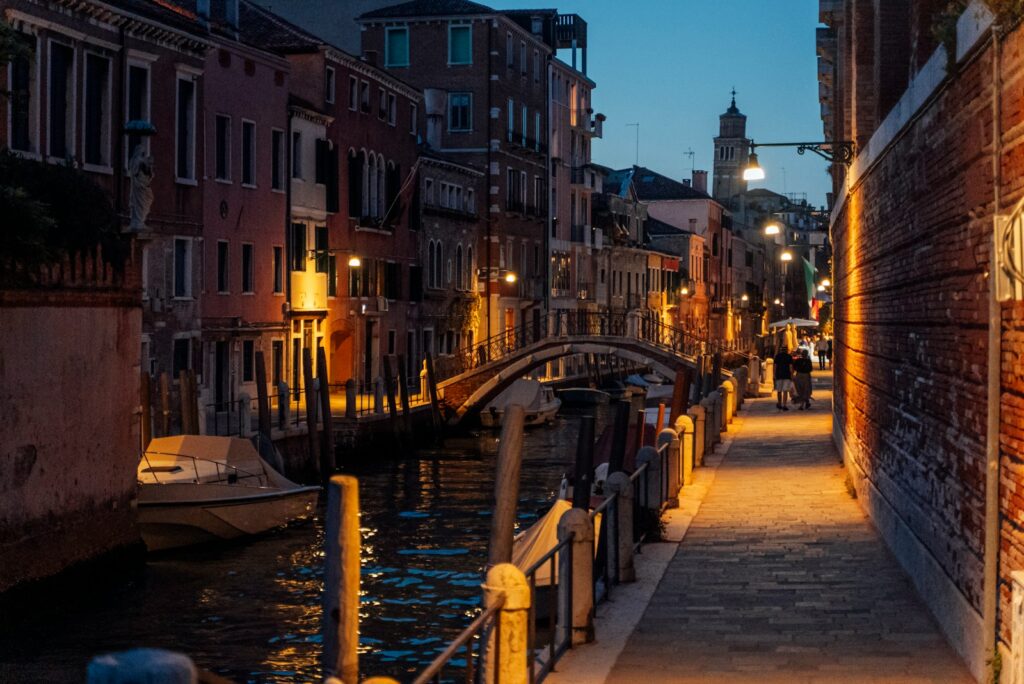 a narrow street with a bridge over a canal